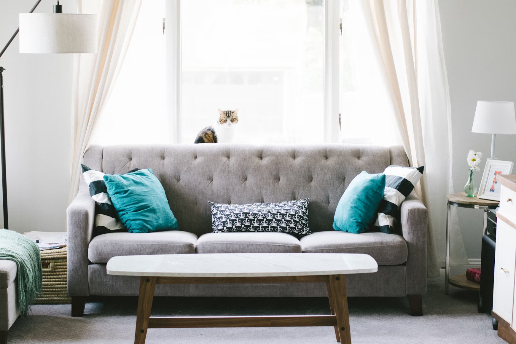 A couch placed right in front of a window.