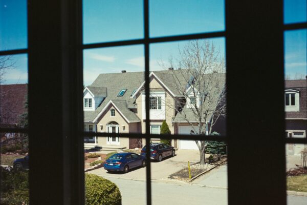 home windows with household window tint looking out onto a quiet residential street.