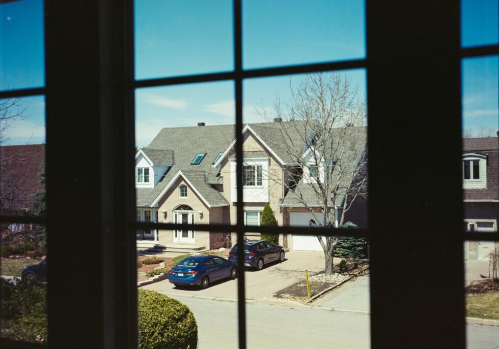 home windows with household window tint looking out onto a quiet residential street.